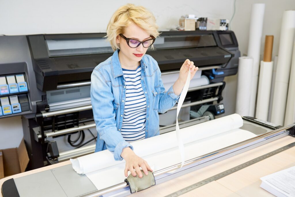 Young woman using plotter